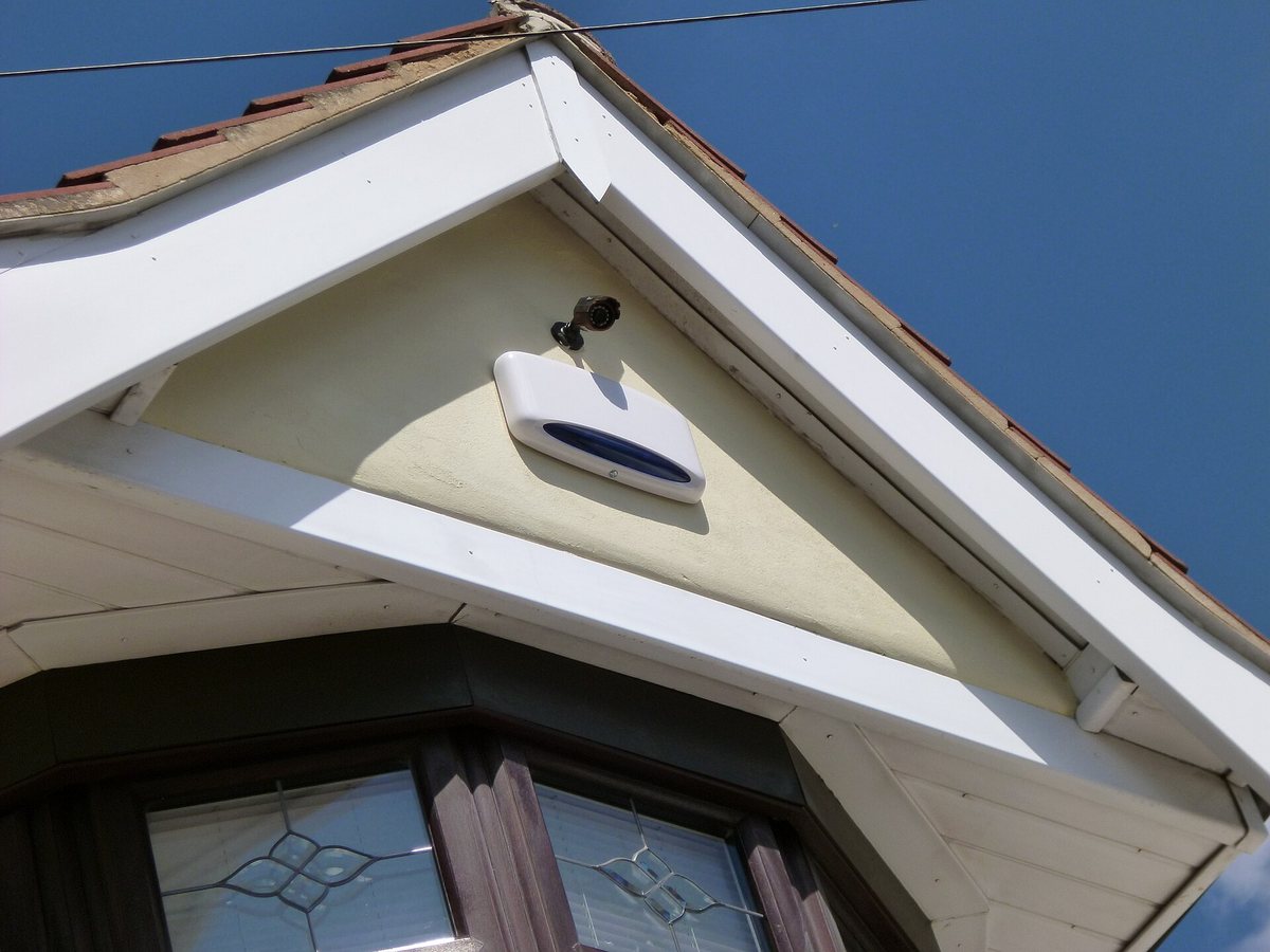 Home alarm siren mounted on exterior wall